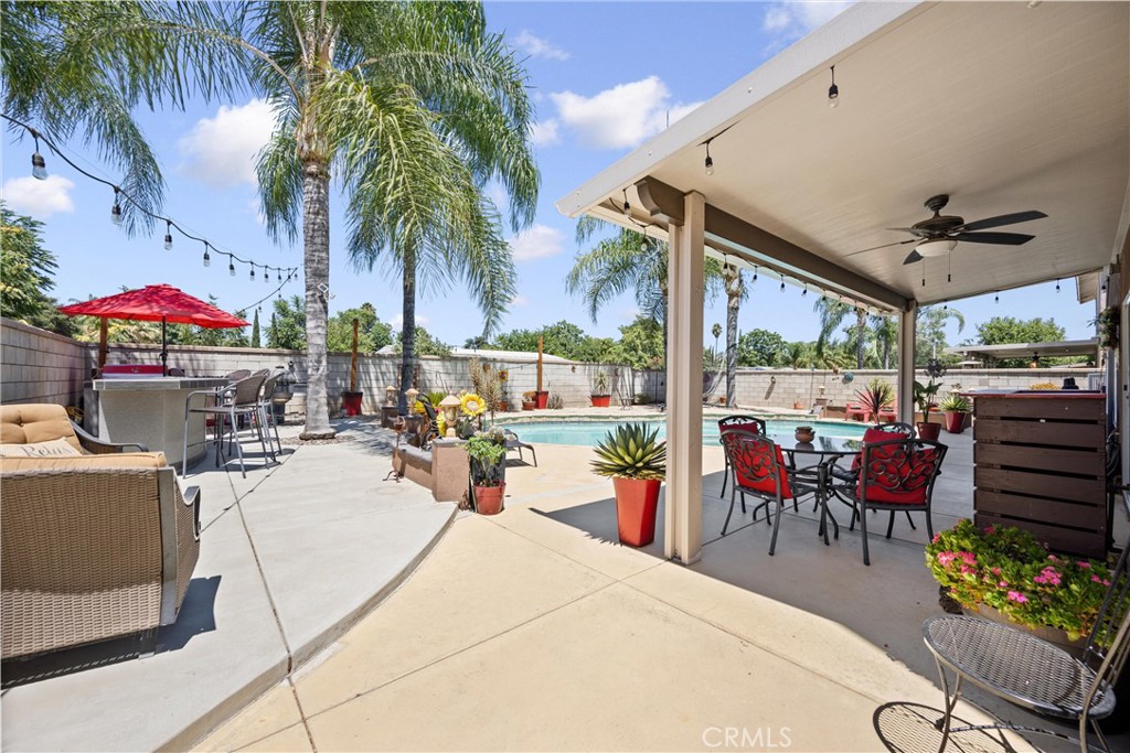 32853 Starlight Street Wildomar, CA 92595 - Photo 31 of 32 a view of a patio with a table and chairs under an umbrella with a potted plant