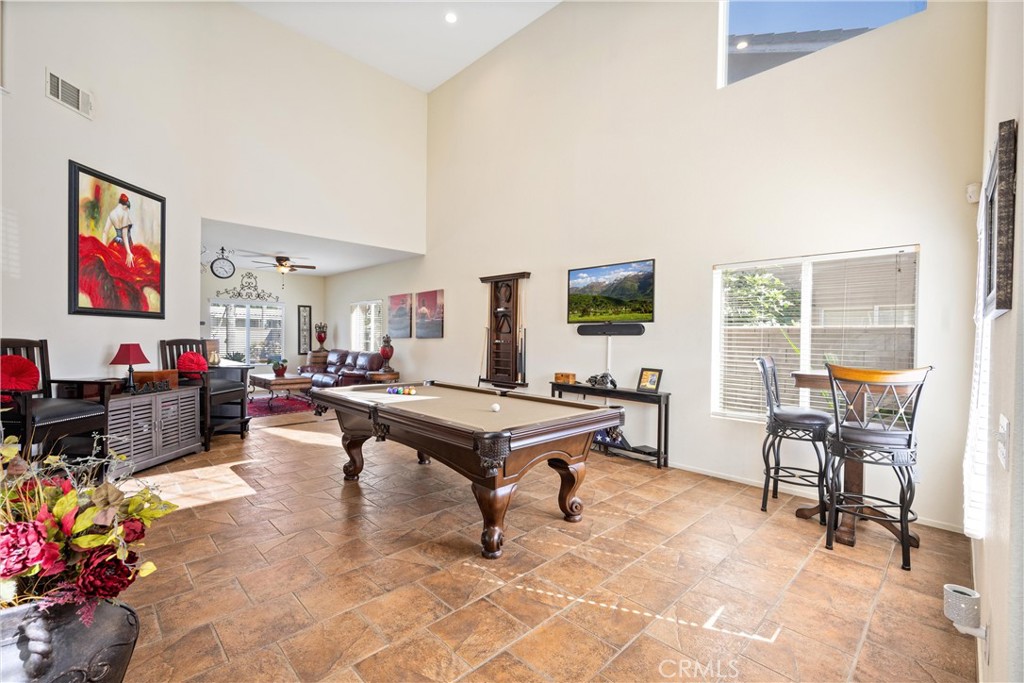 32853 Starlight Street Wildomar, CA 92595 - Photo 4 of 32 a living room with furniture a dining table and a flat screen tv