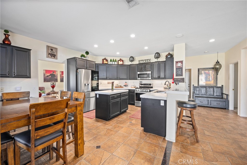 32853 Starlight Street Wildomar, CA 92595 - Photo 10 of 32 a kitchen with a sink refrigerator and cabinets