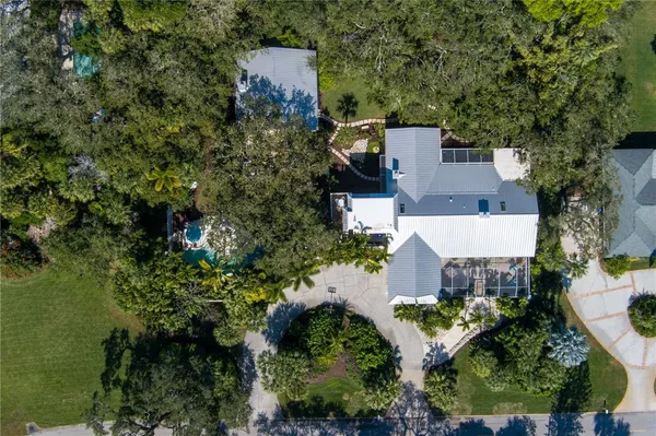 an aerial view of a house with a yard and lake view