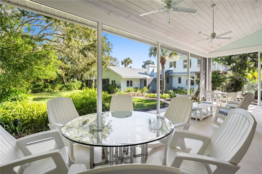 315 Greytwig Road Vero Beach, FL 32963 - Photo 28 of 36 a dining room with furniture a large window and chandelier
