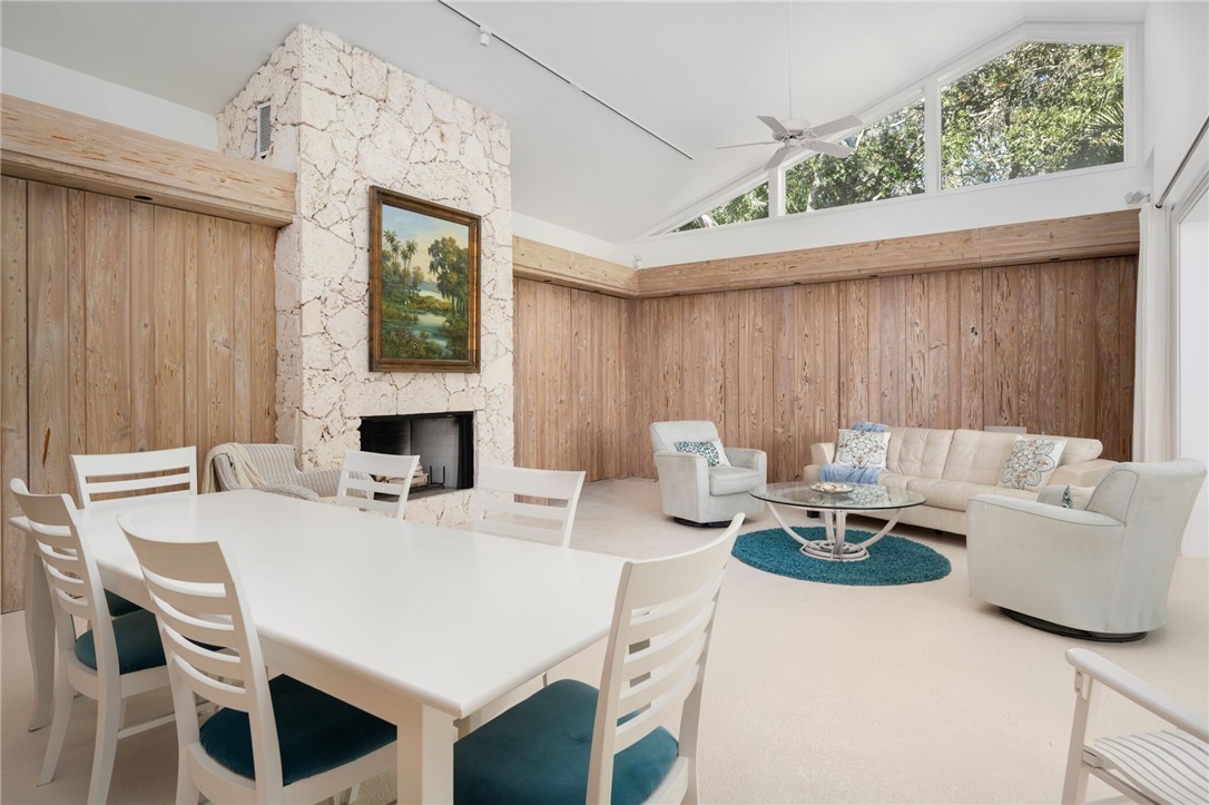 315 Greytwig Road Vero Beach, FL 32963 - Photo 30 of 36 a living room with furniture a table and a fireplace