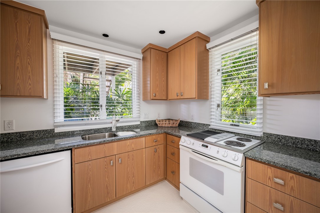 315 Greytwig Road Vero Beach, FL 32963 - Photo 32 of 36 a kitchen with granite countertop a sink stove and cabinets
