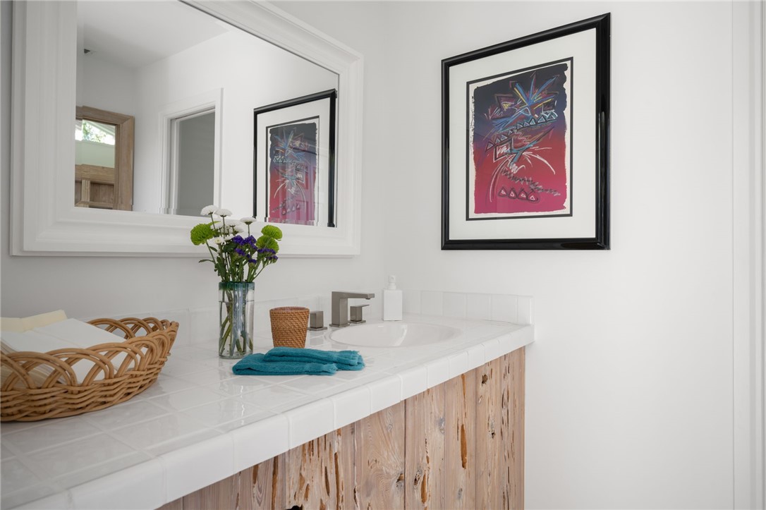 315 Greytwig Road Vero Beach, FL 32963 - Photo 33 of 36 a bathroom with a sink a mirror and a potted plant