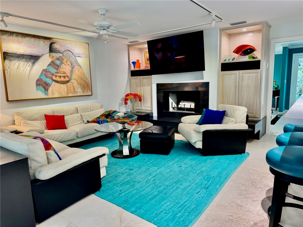 315 Greytwig Road Vero Beach, FL 32963 - Photo 10 of 36 a living room with furniture and a fireplace