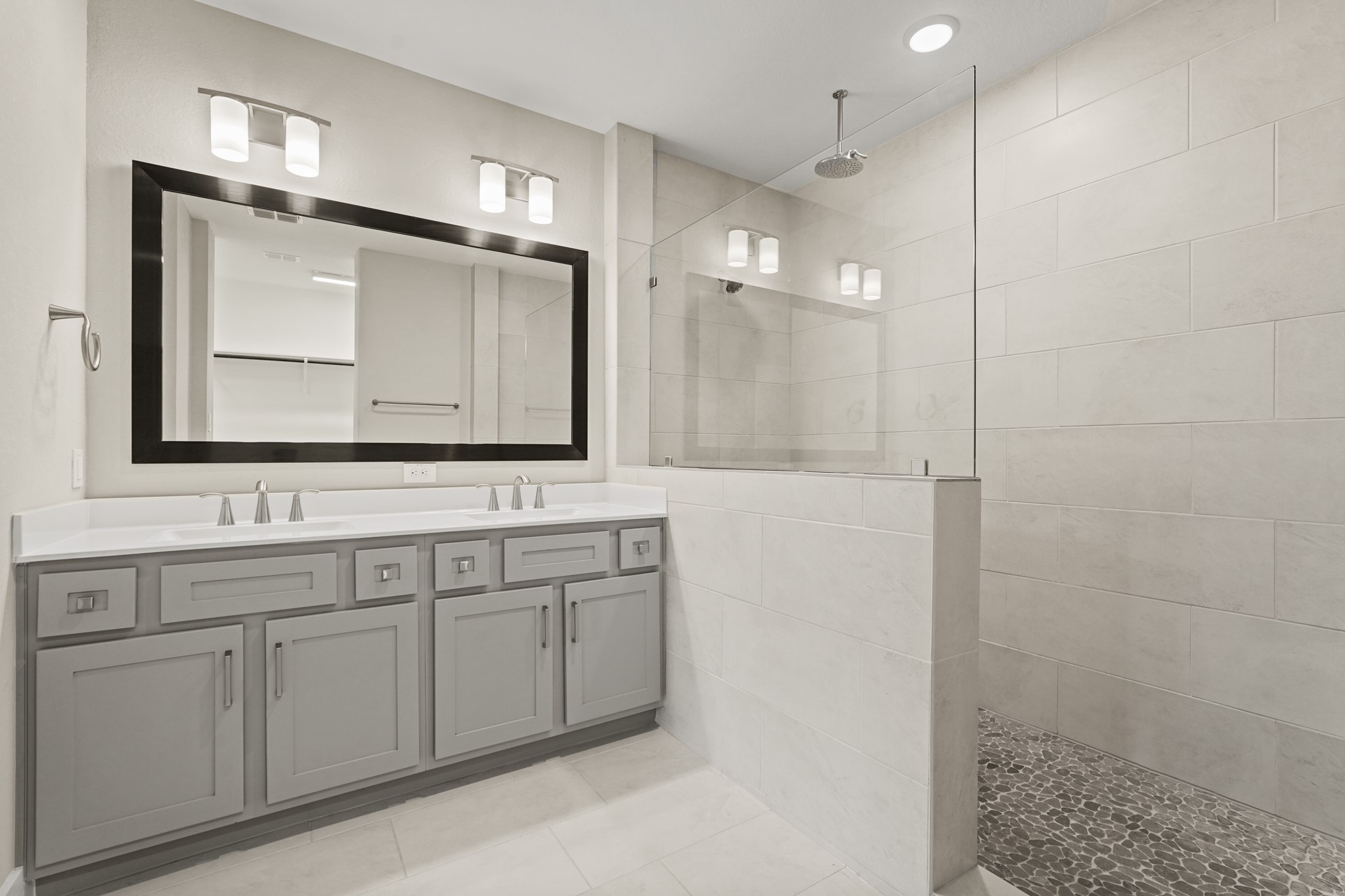 10972 Hewitt Cliff Lane Houston, TX 77043 - Photo 12 of 23 a bathroom with a double vanity sink and mirror