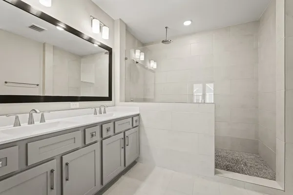 a bathroom with a double vanity sink mirror and double