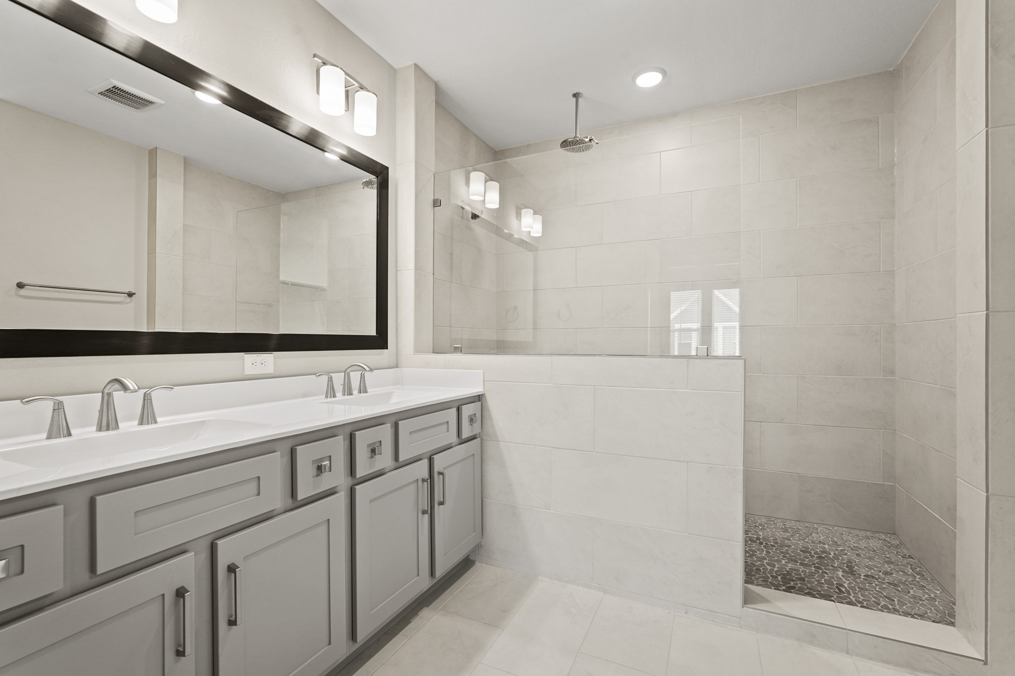 10972 Hewitt Cliff Lane Houston, TX 77043 - Photo 13 of 23 a bathroom with a double vanity sink mirror and double