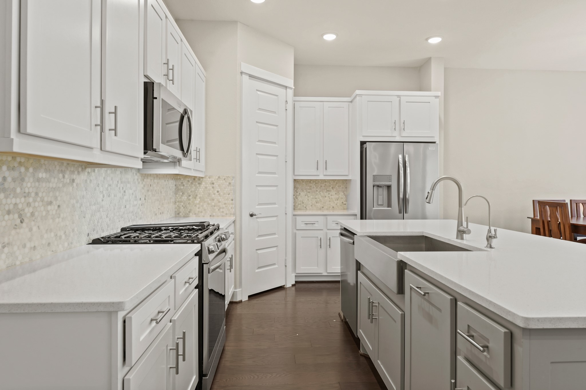10972 Hewitt Cliff Lane Houston, TX 77043 - Photo 16 of 23 a kitchen with white cabinets appliances and sink