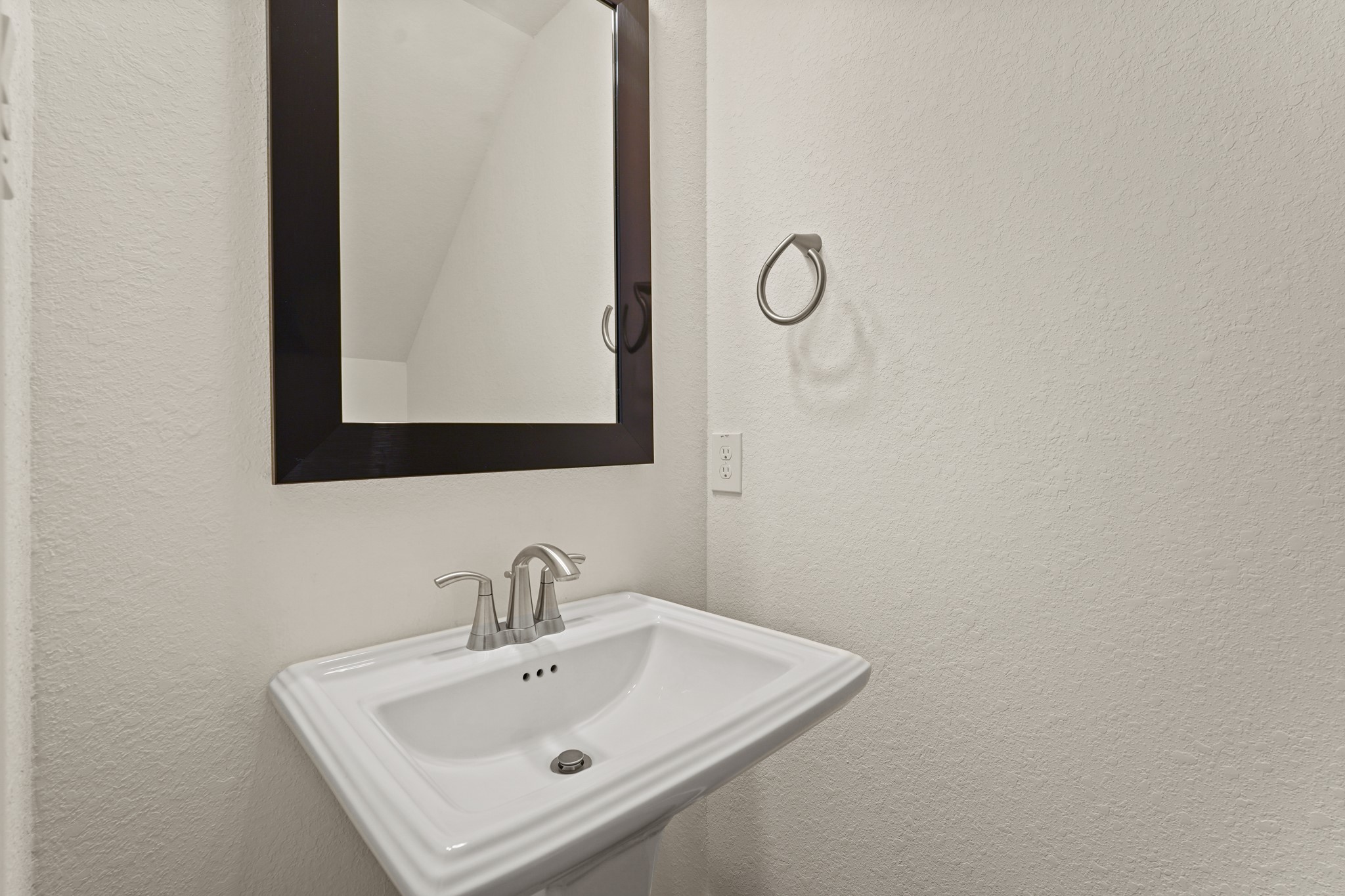 10972 Hewitt Cliff Lane Houston, TX 77043 - Photo 17 of 23 a bathroom with a sink and a mirror