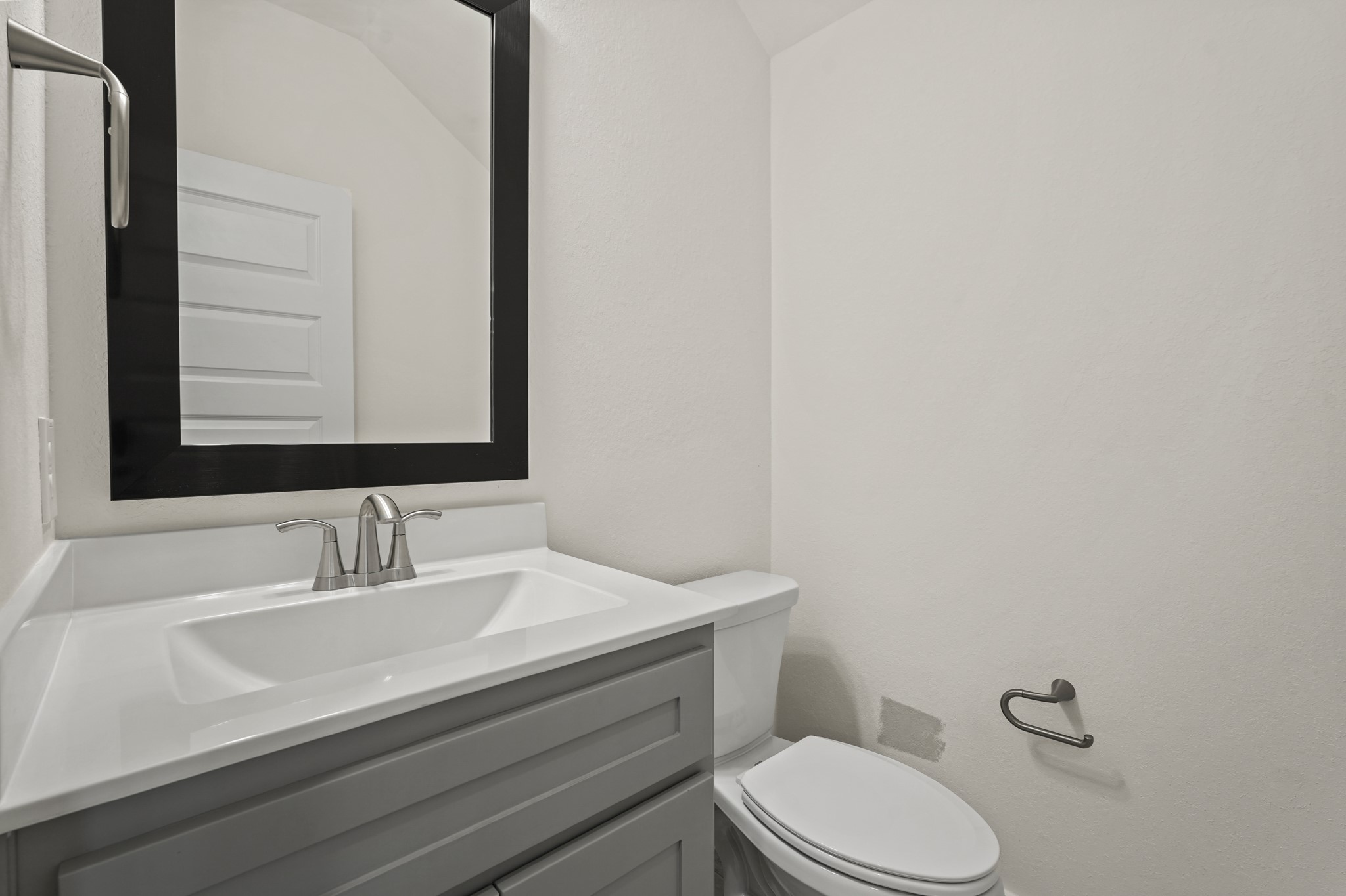 10972 Hewitt Cliff Lane Houston, TX 77043 - Photo 18 of 23 a bathroom with a sink a toilet and mirror