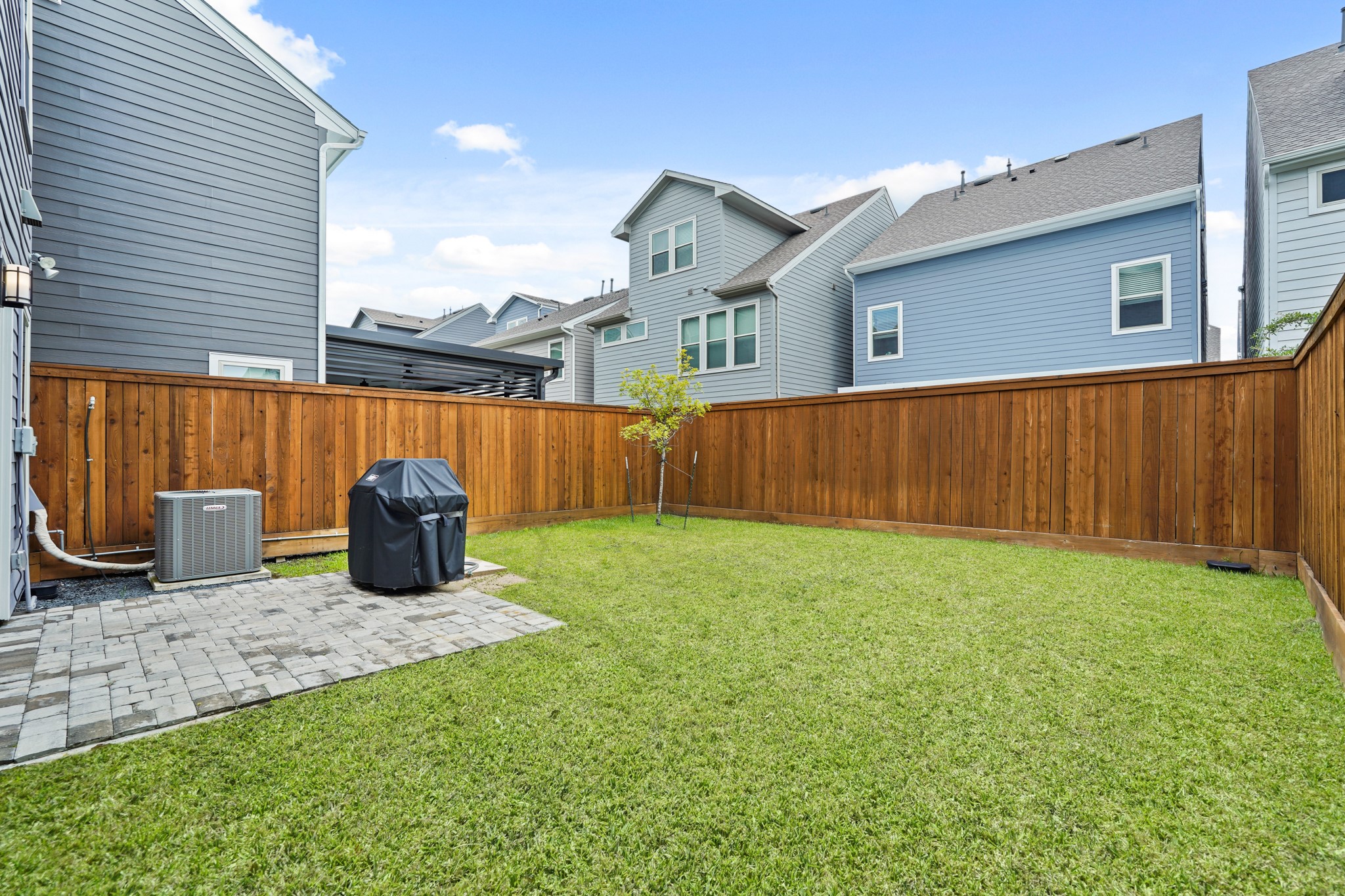 10972 Hewitt Cliff Lane Houston, TX 77043 - Photo 23 of 23 a view of a backyard with table and chairs and wooden fence