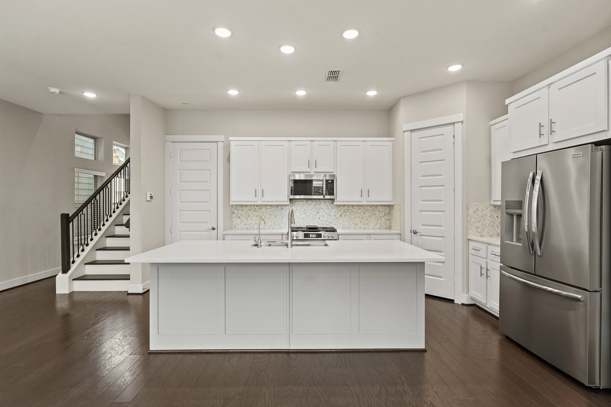 10972 Hewitt Cliff Lane Houston, TX 77043 - Photo 4 of 23 a kitchen with stainless steel appliances a sink and a refrigerator