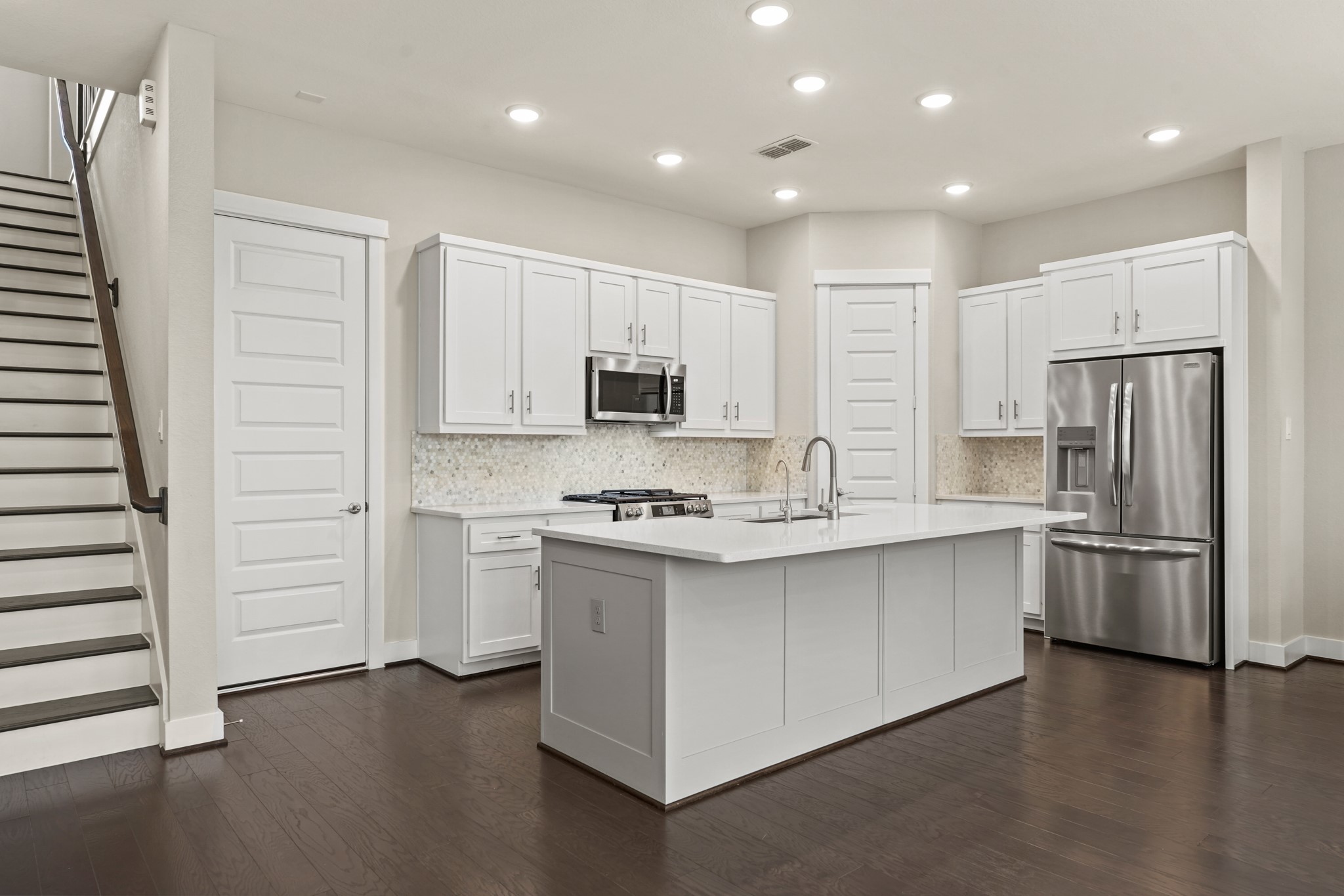 10972 Hewitt Cliff Lane Houston, TX 77043 - Photo 5 of 23 a kitchen with stainless steel appliances a stove a sink and a refrigerator
