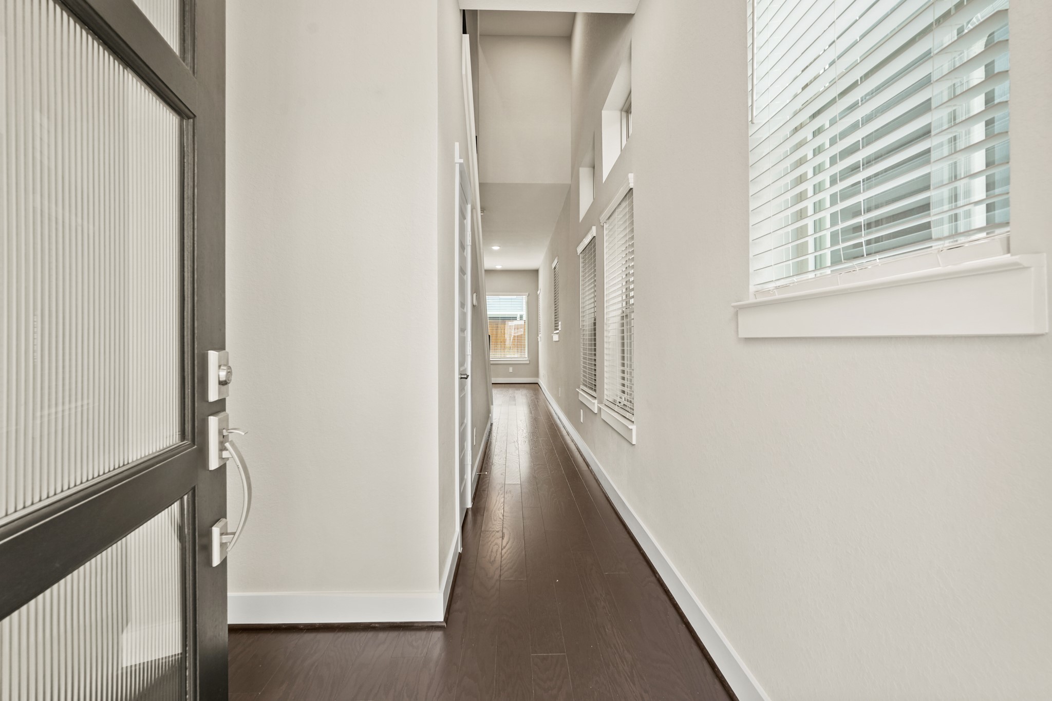 10972 Hewitt Cliff Lane Houston, TX 77043 - Photo 6 of 23 a view of a hallway with a window