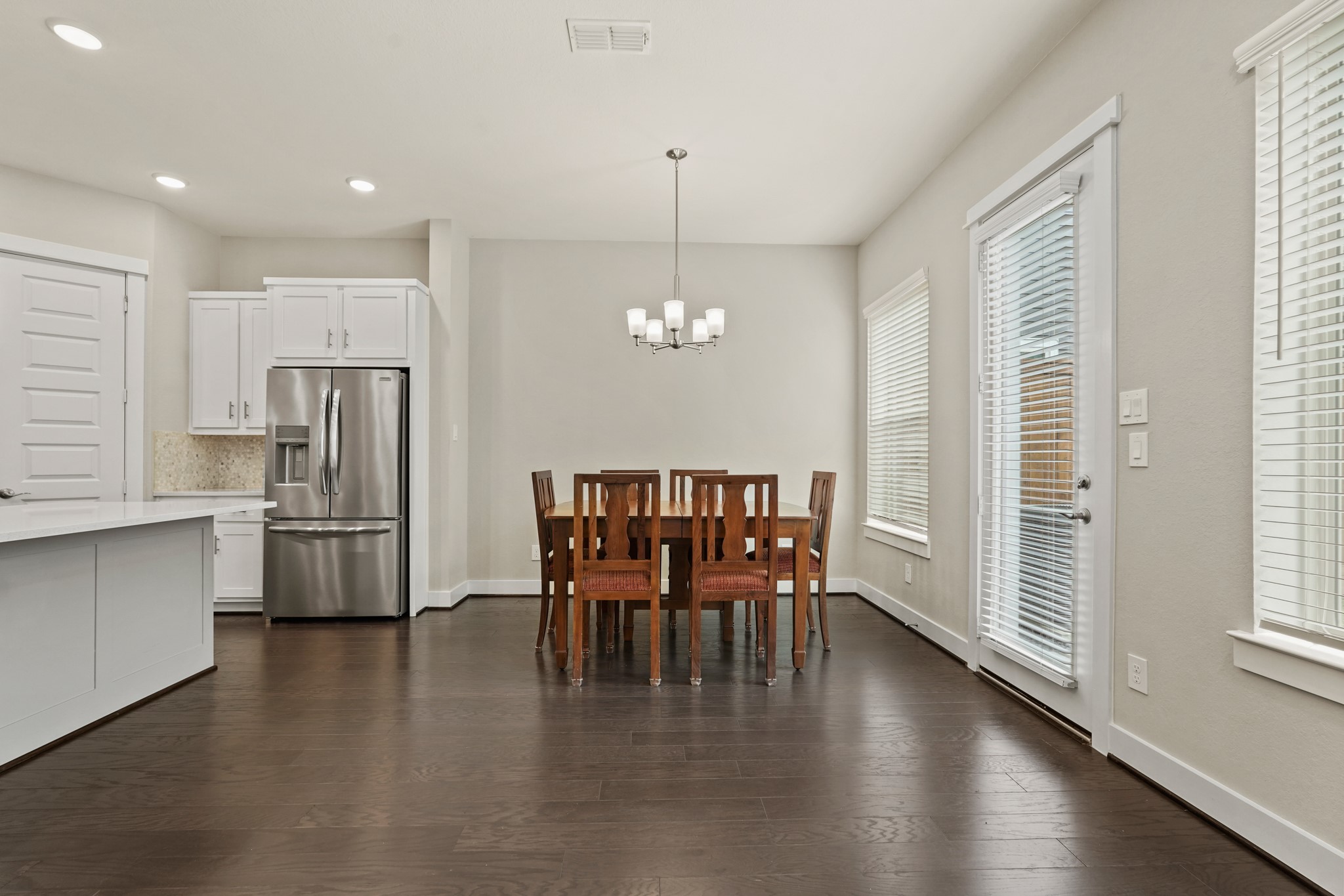 10972 Hewitt Cliff Lane Houston, TX 77043 - Photo 8 of 23 a view of a dining room with furniture window and wooden floor
