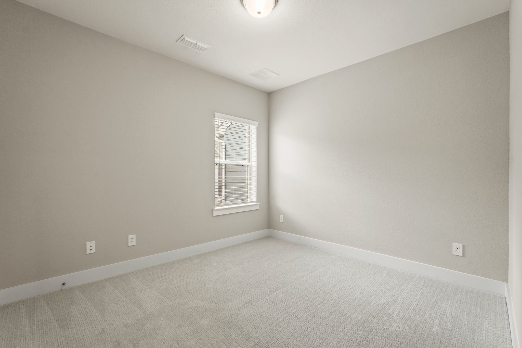 10972 Hewitt Cliff Lane Houston, TX 77043 - Photo 9 of 23 an empty room with a window