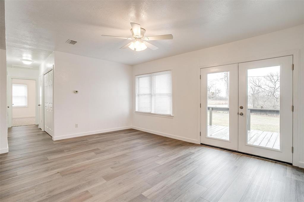 3105 Acton School Road Granbury, TX 76049 - Photo 12 of 40 a view of an empty room with wooden floor and a window