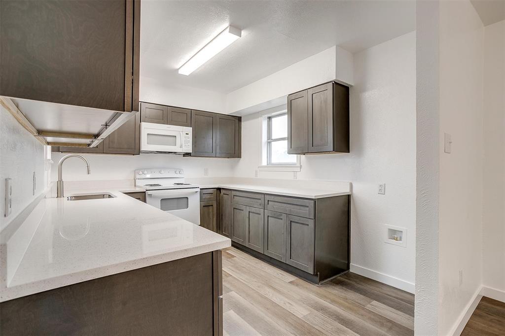 3105 Acton School Road Granbury, TX 76049 - Photo 13 of 40 a kitchen with stainless steel appliances granite countertop a sink and a stove top oven