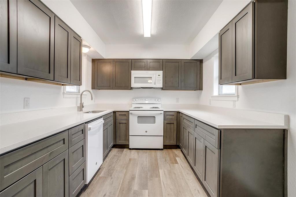 3105 Acton School Road Granbury, TX 76049 - Photo 14 of 40 a kitchen with a sink stove and cabinets