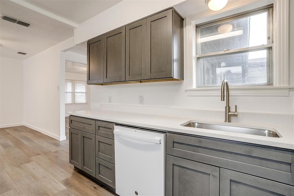 3105 Acton School Road Granbury, TX 76049 - Photo 16 of 40 a kitchen with a sink and cabinets