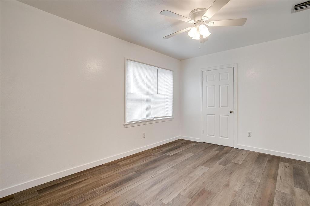 3105 Acton School Road Granbury, TX 76049 - Photo 17 of 40 a view of a room with wooden floor and a ceiling fan