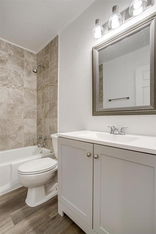 3105 Acton School Road Granbury, TX 76049 - Photo 26 of 40 a bathroom with a toilet a sink a mirror and vanity