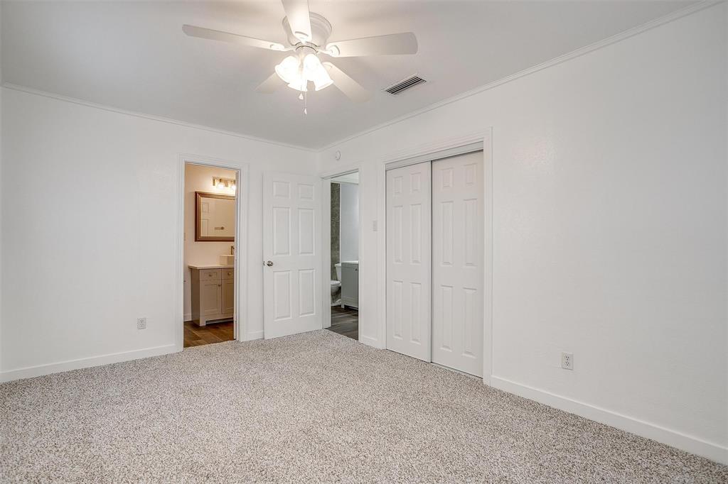3105 Acton School Road Granbury, TX 76049 - Photo 29 of 40 an empty room with closet and a ceiling fan