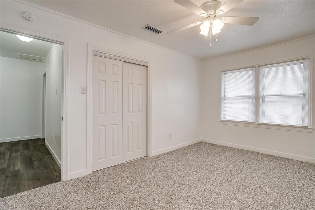 3105 Acton School Road Granbury, TX 76049 - Photo 30 of 40 an empty room with chandelier fan and windows