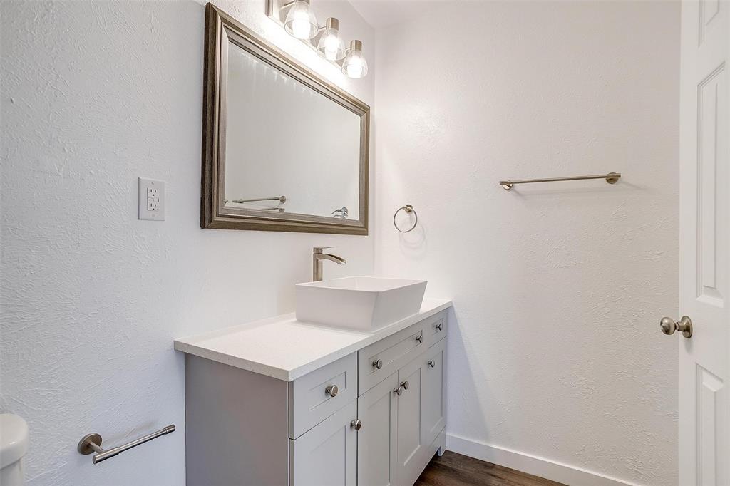 3105 Acton School Road Granbury, TX 76049 - Photo 34 of 40 a bathroom with a sink a vanity and a mirror
