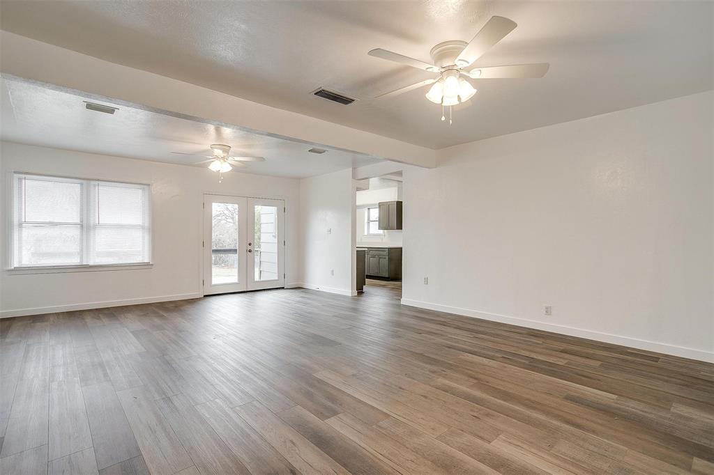 3105 Acton School Road Granbury, TX 76049 - Photo 7 of 40 a view of an empty room with window and wooden floor