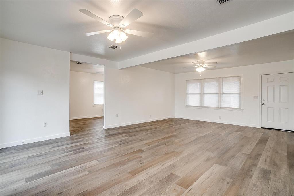 3105 Acton School Road Granbury, TX 76049 - Photo 10 of 40 a view of an empty room with window and wooden floor