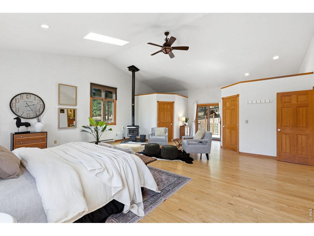560 Quillan Gulch Road Loveland, CO 80537 - Photo 15 of 49 Primary has a wood stove, plus sliding glass doors out to second deck in back