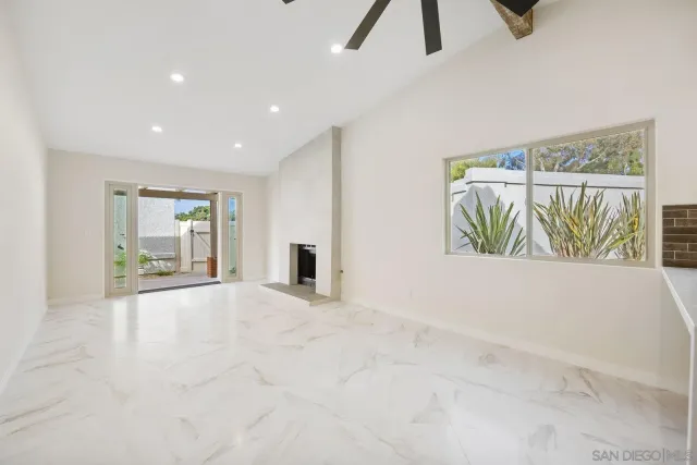 a view of an empty room with windows