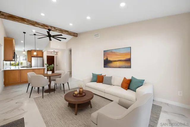 a living room with furniture a rug and white walls