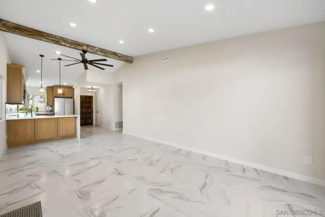 a view of a kitchen with a sink and a refrigerator