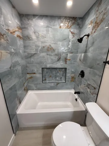a bathroom with a bathtub and a toilet