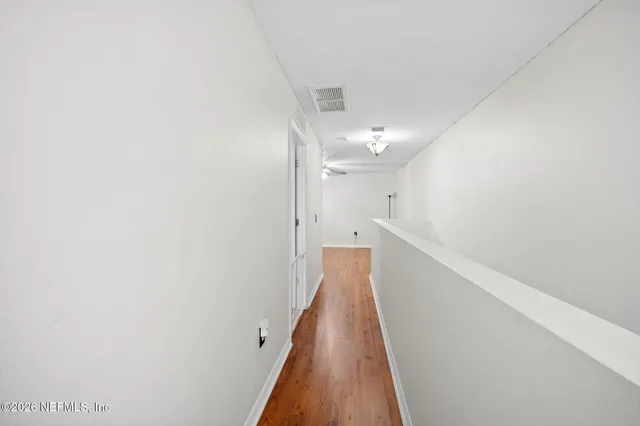 a view of a hallway with stairs
