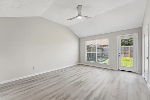a view of an house with backyard and porch