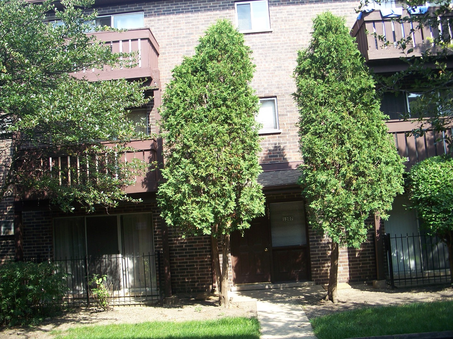 1307 Turtle Creek Circle Palatine, IL 60074 - Photo 1 of 3 a front view of a house with garden
