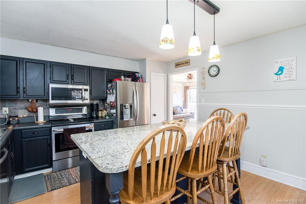 4043 Windward Drive Tega Cay, SC 29708 - Photo 11 of 25 a kitchen with stainless steel appliances granite countertop a stove top oven a refrigerator a sink and dishwasher