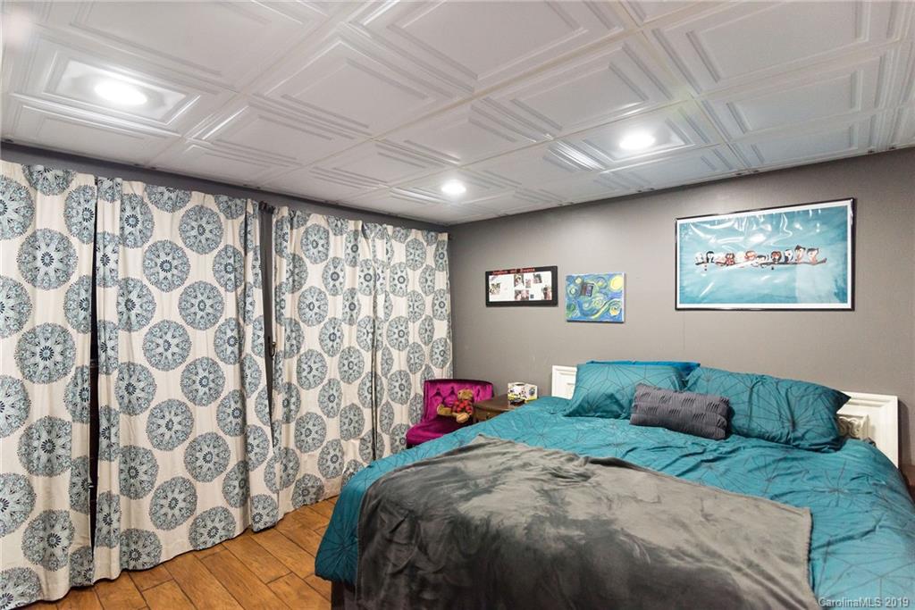 4043 Windward Drive Tega Cay, SC 29708 - Photo 12 of 25 a bedroom with a bed and a painting on the wall