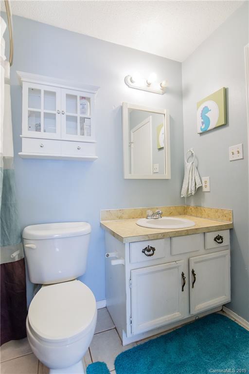 4043 Windward Drive Tega Cay, SC 29708 - Photo 15 of 25 a bathroom with a granite countertop toilet sink and mirror