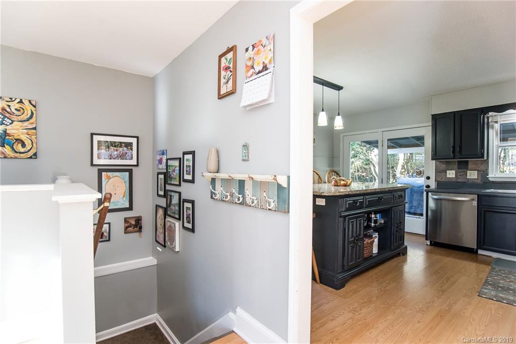 4043 Windward Drive Tega Cay, SC 29708 - Photo 16 of 25 a kitchen with stainless steel appliances granite countertop a refrigerator and a stove