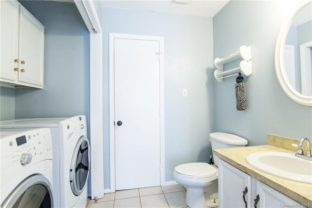 4043 Windward Drive Tega Cay, SC 29708 - Photo 18 of 25 a white toilet sitting next to a bathroom sink