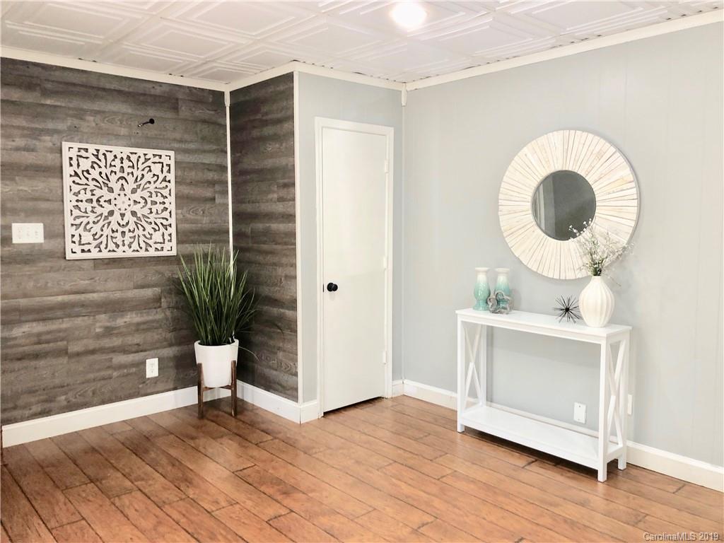 4043 Windward Drive Tega Cay, SC 29708 - Photo 3 of 25 a view of a room with wooden floor and a potted plant