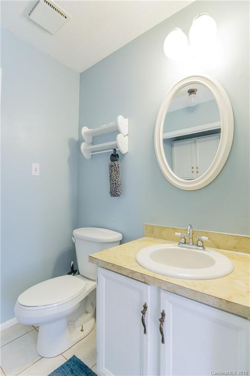 4043 Windward Drive Tega Cay, SC 29708 - Photo 21 of 25 a bathroom with a sink a toilet and mirror