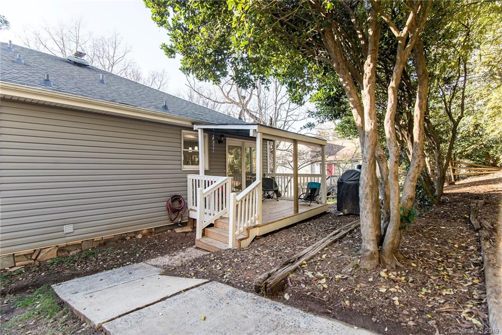 4043 Windward Drive Tega Cay, SC 29708 - Photo 23 of 25 a white house that has a tree in front of the house