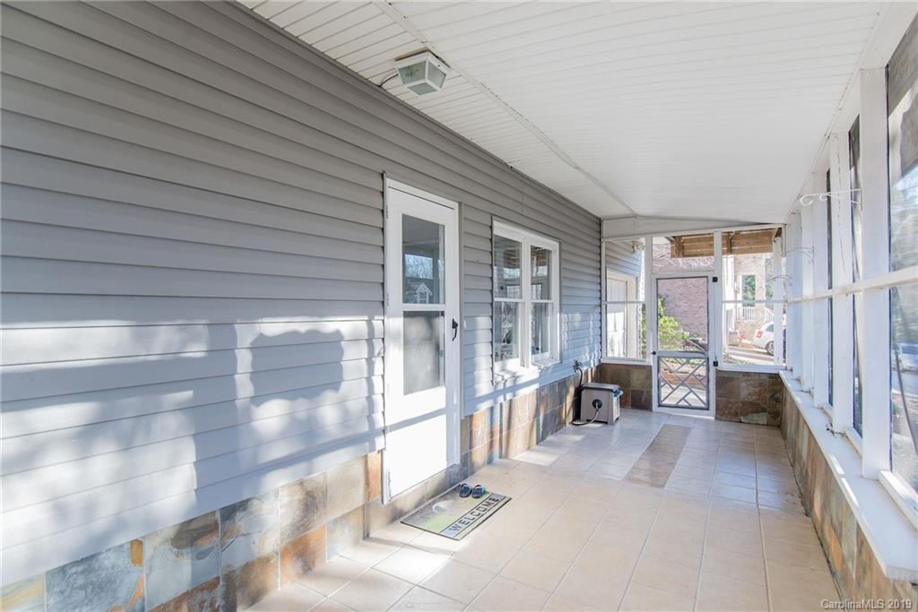 4043 Windward Drive Tega Cay, SC 29708 - Photo 25 of 25 a view of a porch with chairs and floor to ceiling window