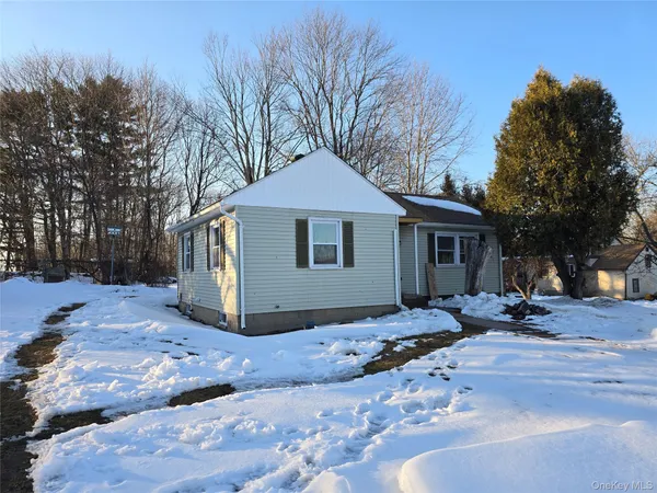 a view of a house with a yard covered with snow in the backyard